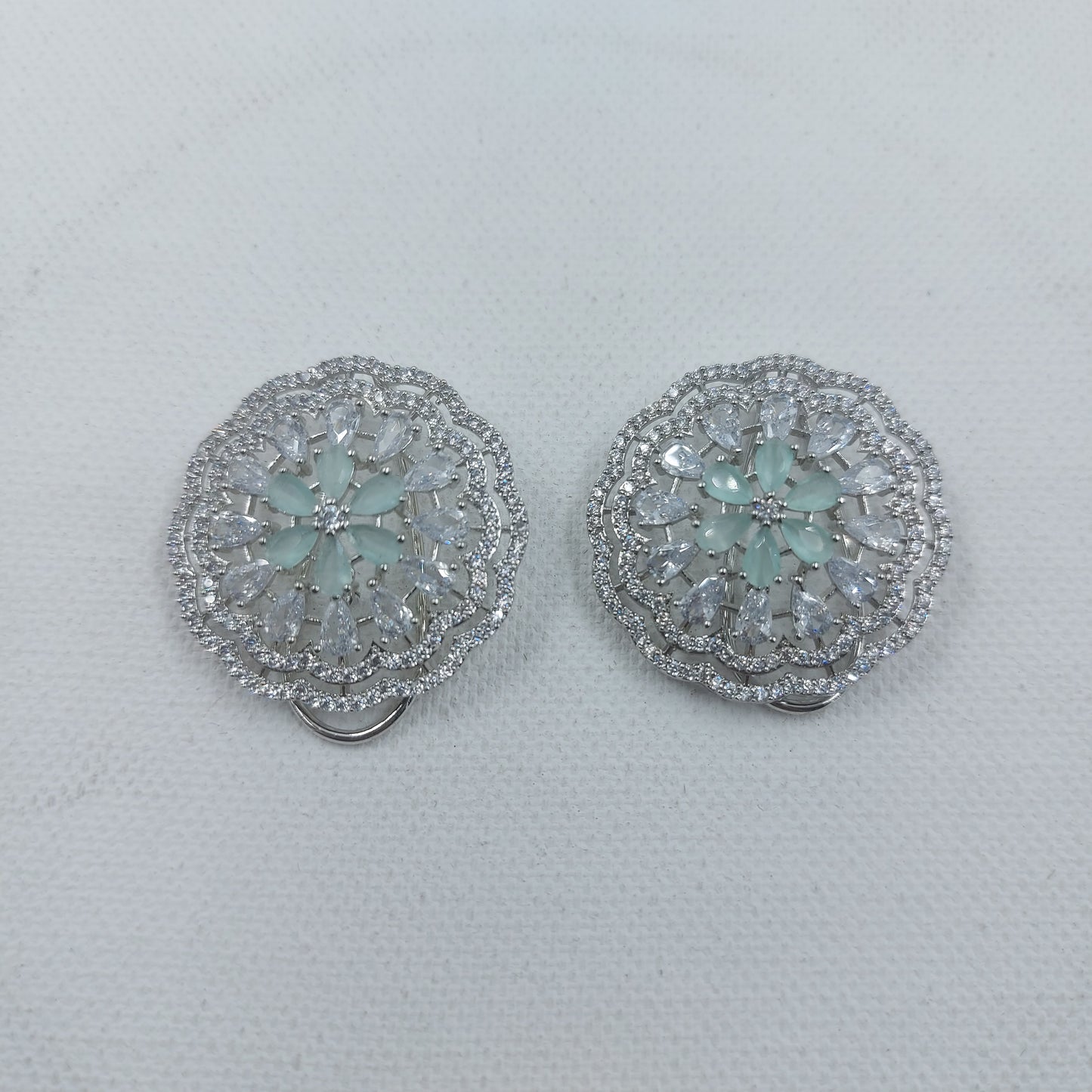 Buy Round Shaped Flower Design Turquoise Color American Diamond AD Silver Polish Stud Earrings